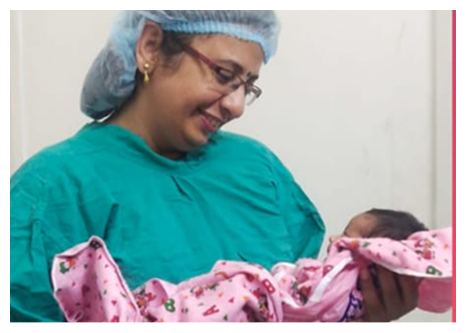 Specialist in scrubs holding a newborn